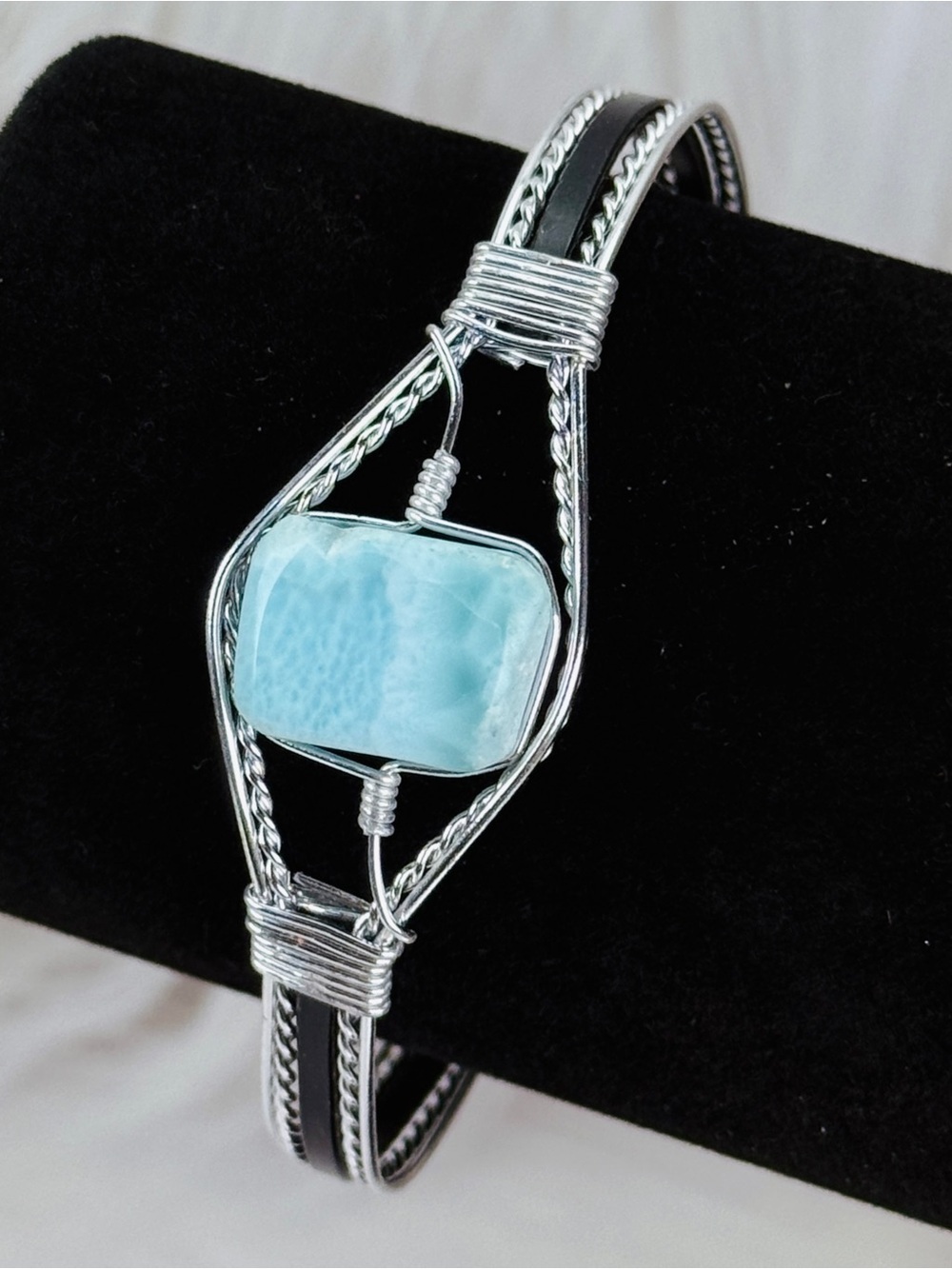 Silvertone wire wrapped bracelet with black and blue accents